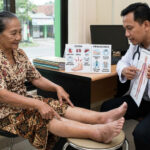Lansia mengalami kaki bengkak akibat edema sambil berkonsultasi dengan dokter mengenai penyebab dan penanganannya.